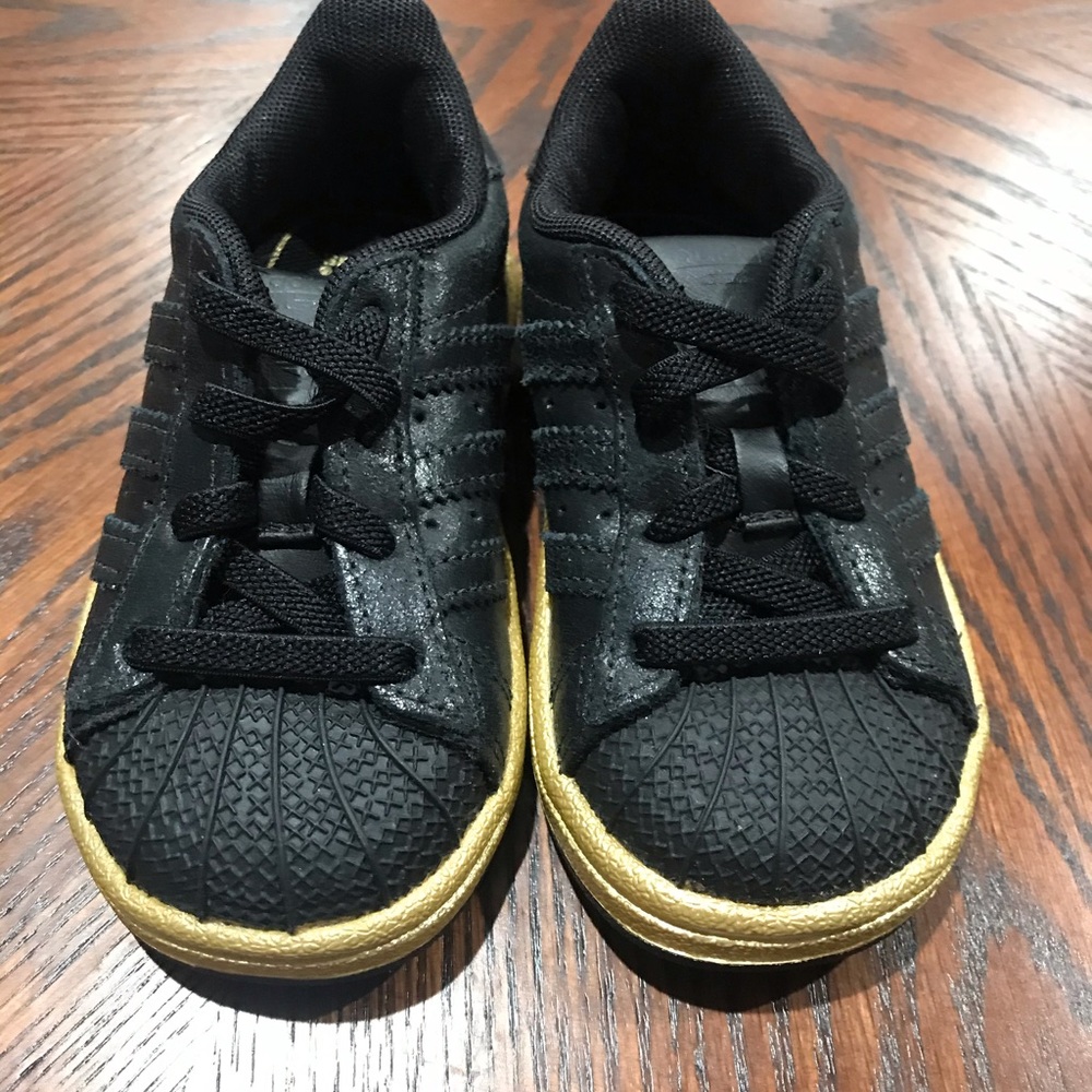 Black and gold soles adidas girl shoes
